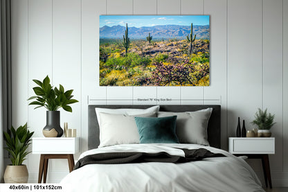 a serene desert landscape with cacti and wildflowers, featuring a clear blue sky and distant mountains.