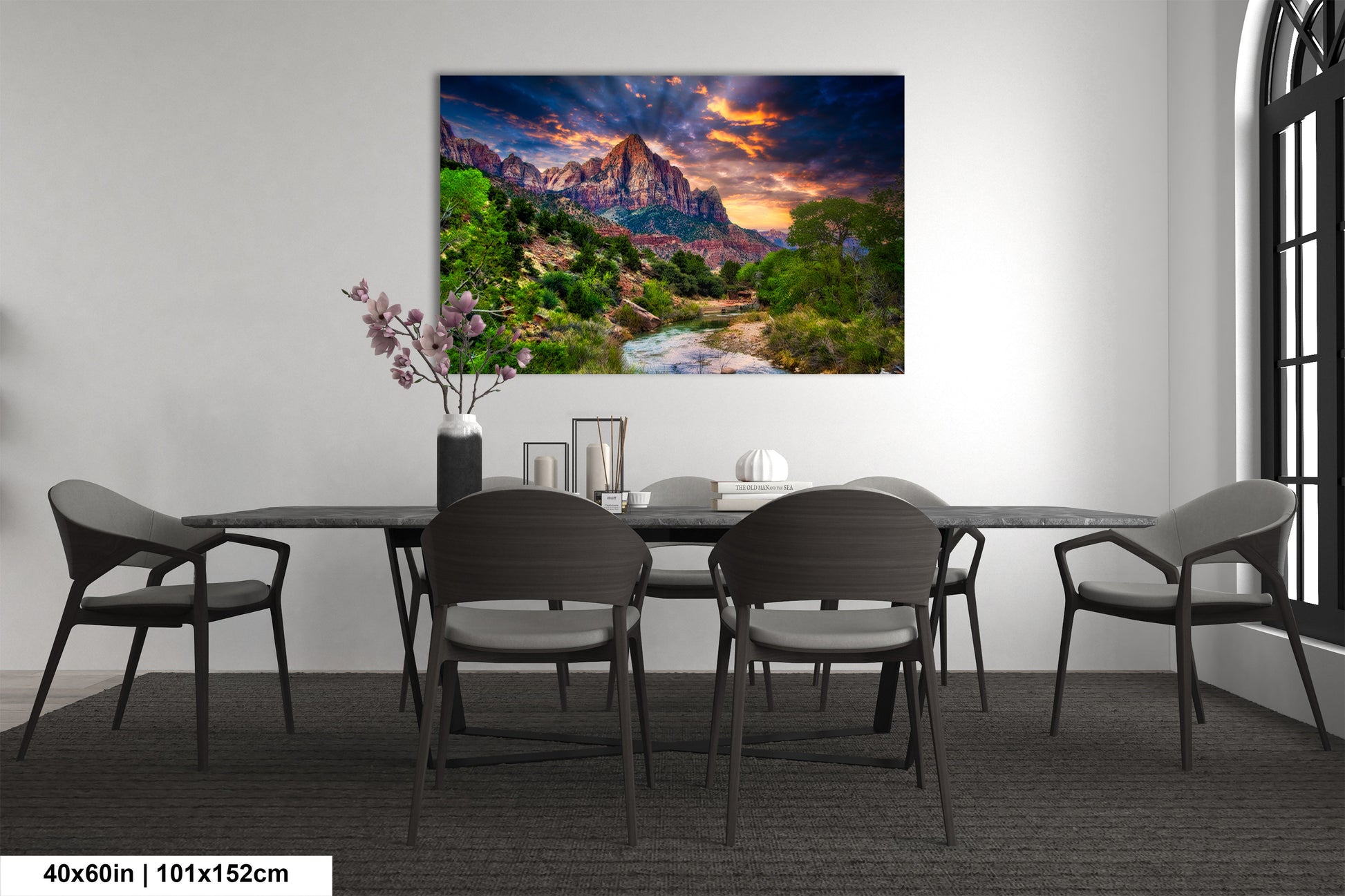 a dining room table with chairs and a painting on the wall