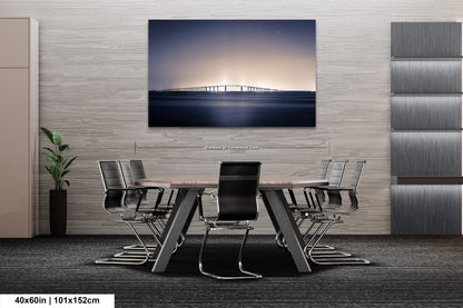 a dining room table with chairs and a painting on the wall