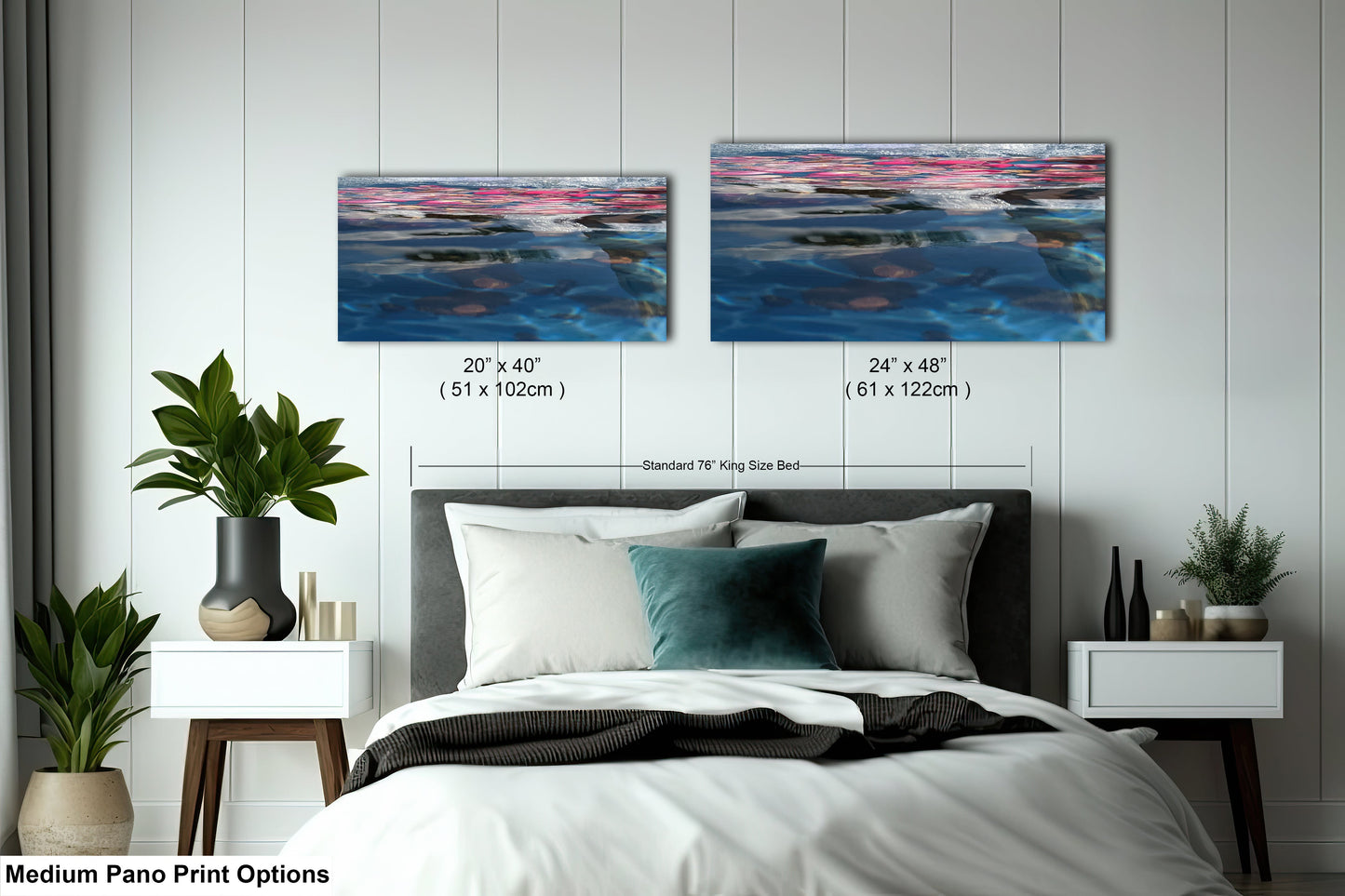 a bed with a white comforter and two paintings on the wall