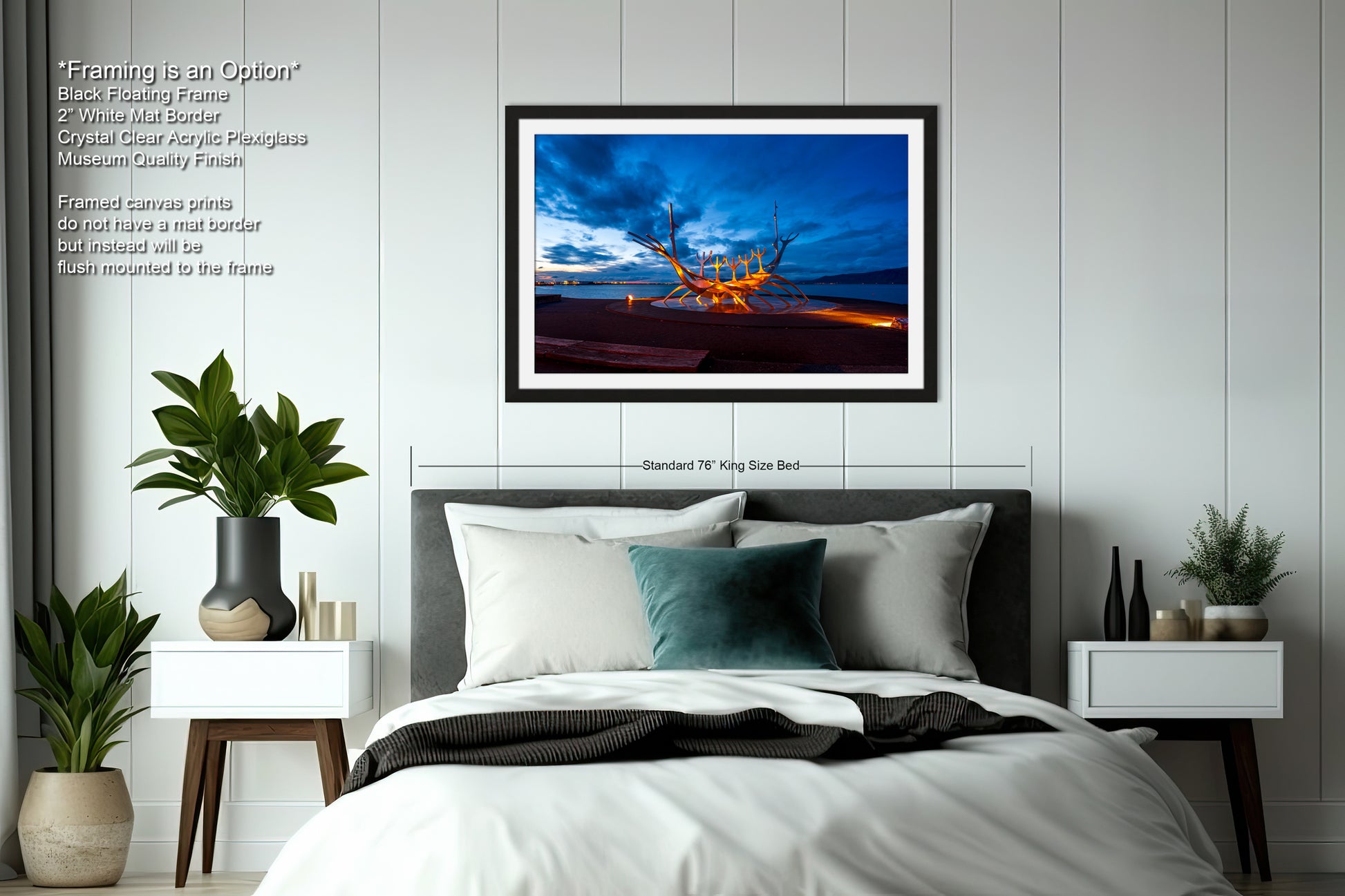 a bedroom with a bed and a picture hanging on the wall