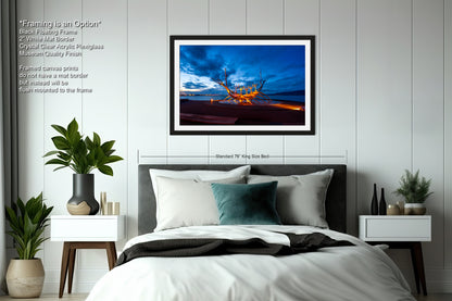 a bedroom with a bed and a picture hanging on the wall