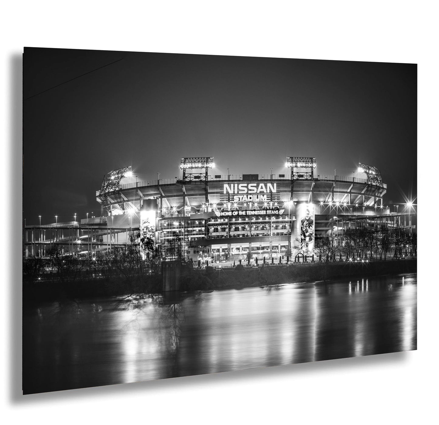 a black and white photo of a stadium at night
