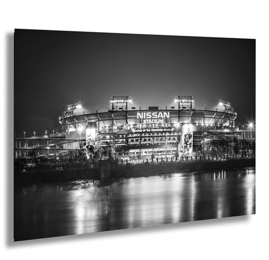 a black and white photo of a stadium at night