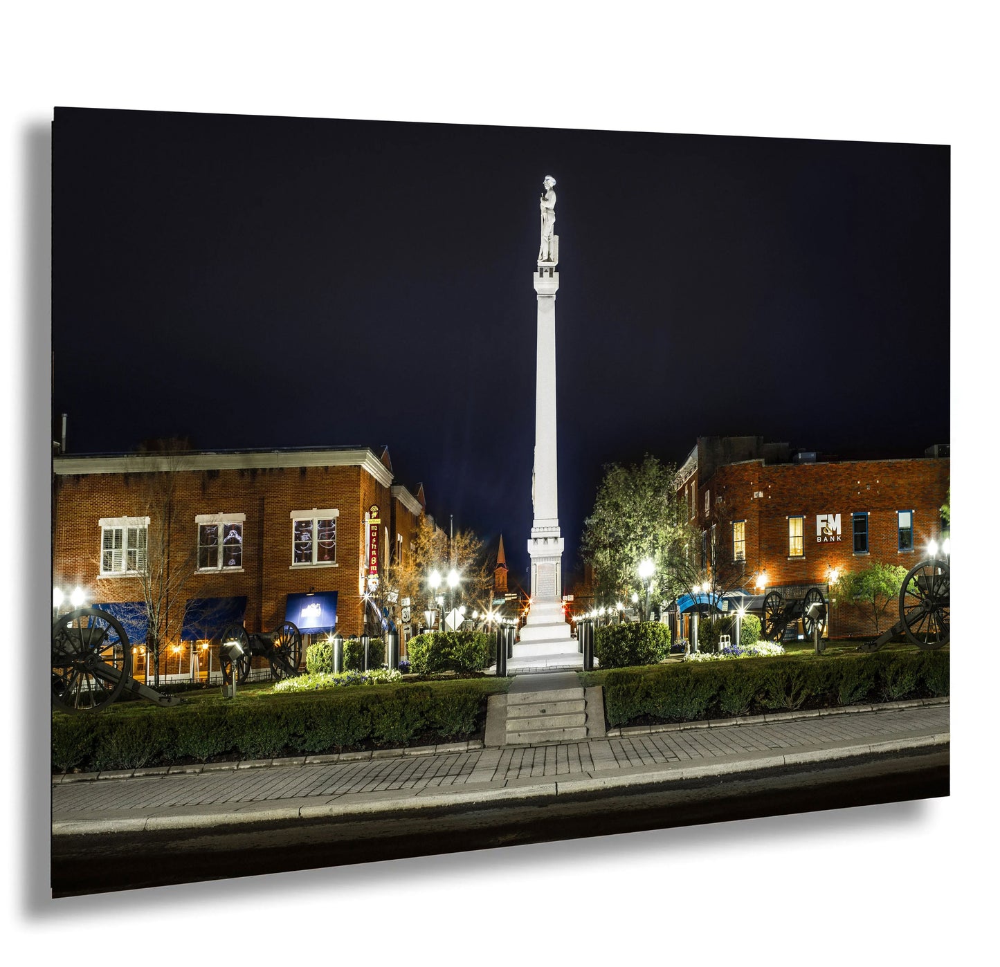 a tall white obelisk sitting in the middle of a park