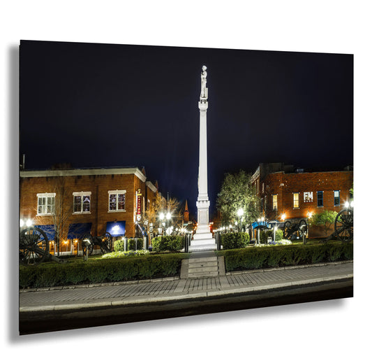 a tall white obelisk sitting in the middle of a park