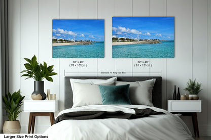 a bedroom with a bed and two pictures on the wall