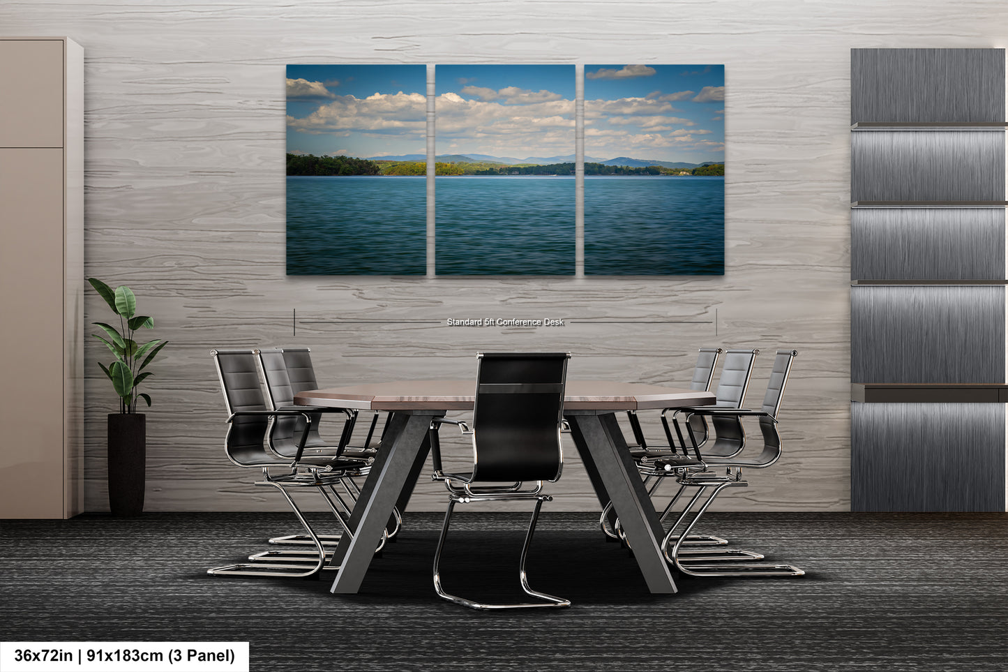 A modern office space with a large, three-panel landscape painting depicting a serene lake and sky above it. The painting is mounted on a gray wall above a wooden table surrounded by black chairs.
