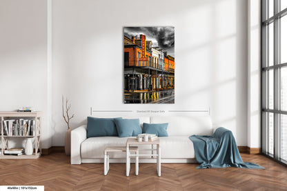 a living room with a white couch and a painting on the wall