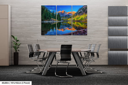 a dining room with a table and chairs and a painting on the wall