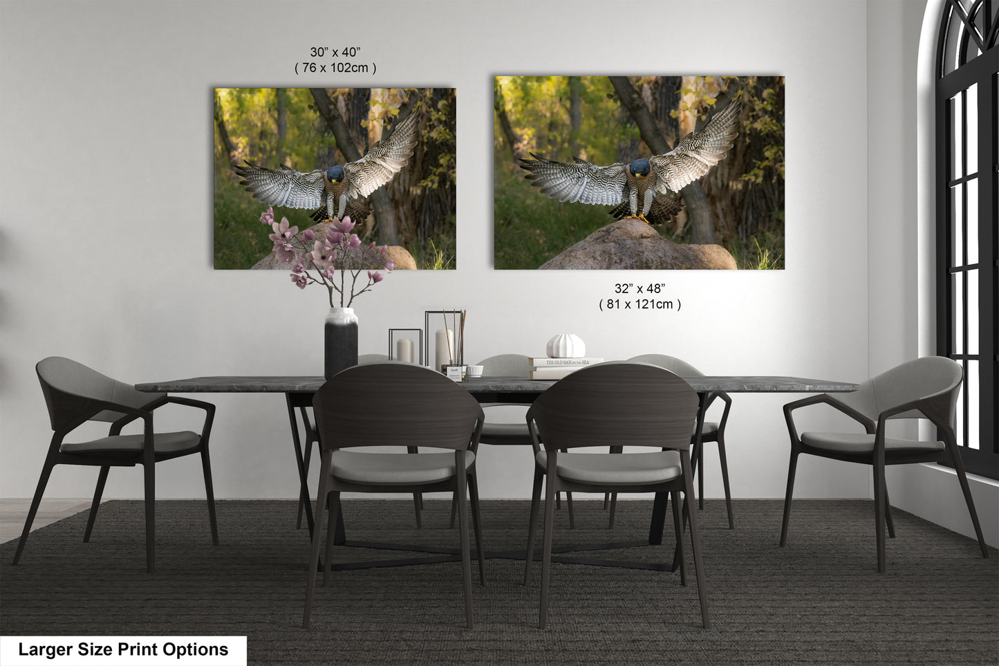 a dining room with a large dining table and six chairs. Two framed photographs of birds are displayed on the wall above the table.