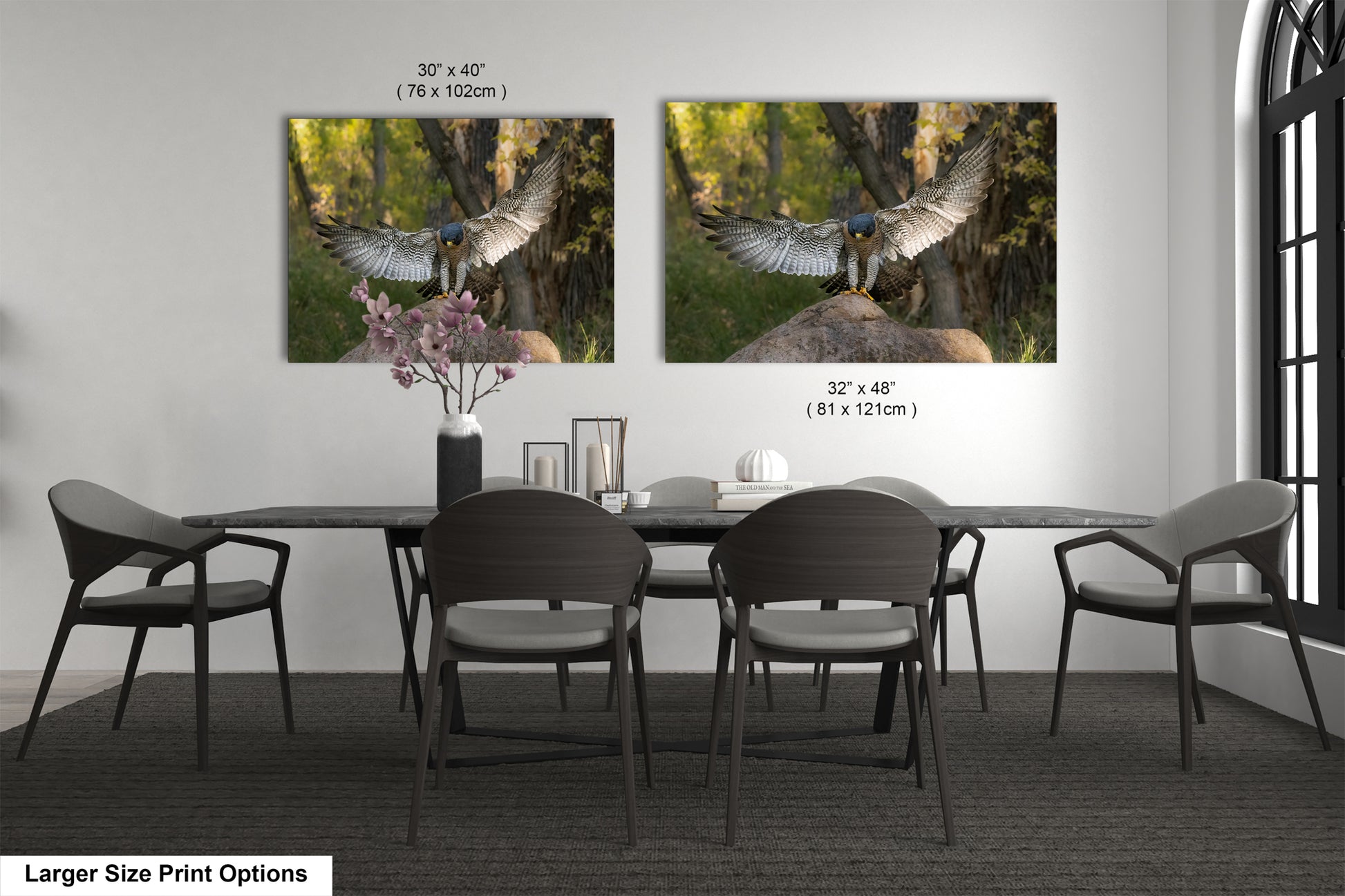 a dining room with a large dining table and six chairs. Two framed photographs of birds are displayed on the wall above the table.