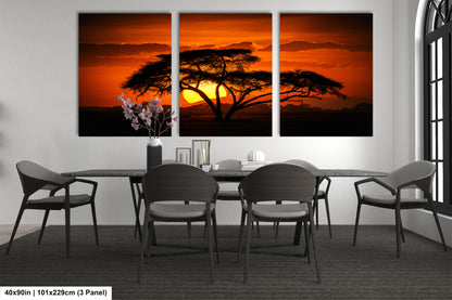 a dining room table with four chairs and a painting of a tree