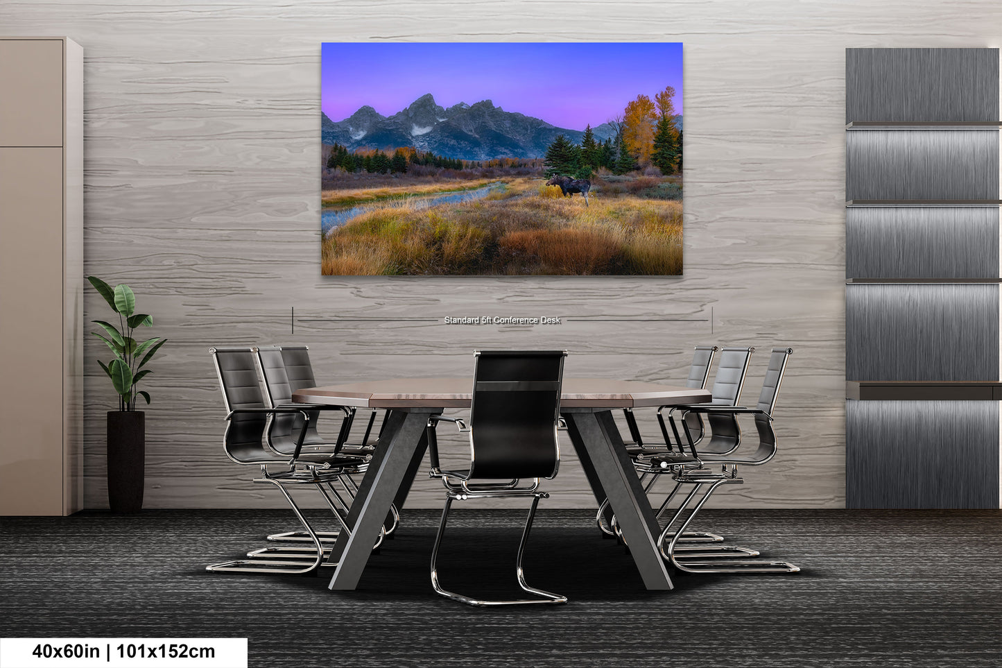 a dining room table with a painting of a mountain range in the background