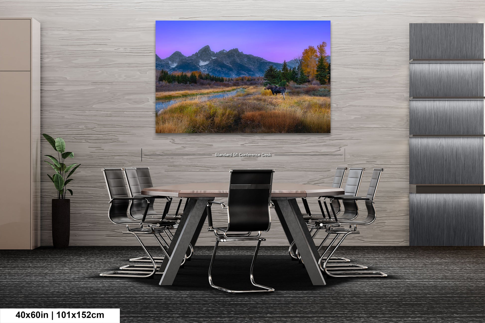 a dining room table with a painting of a mountain range in the background