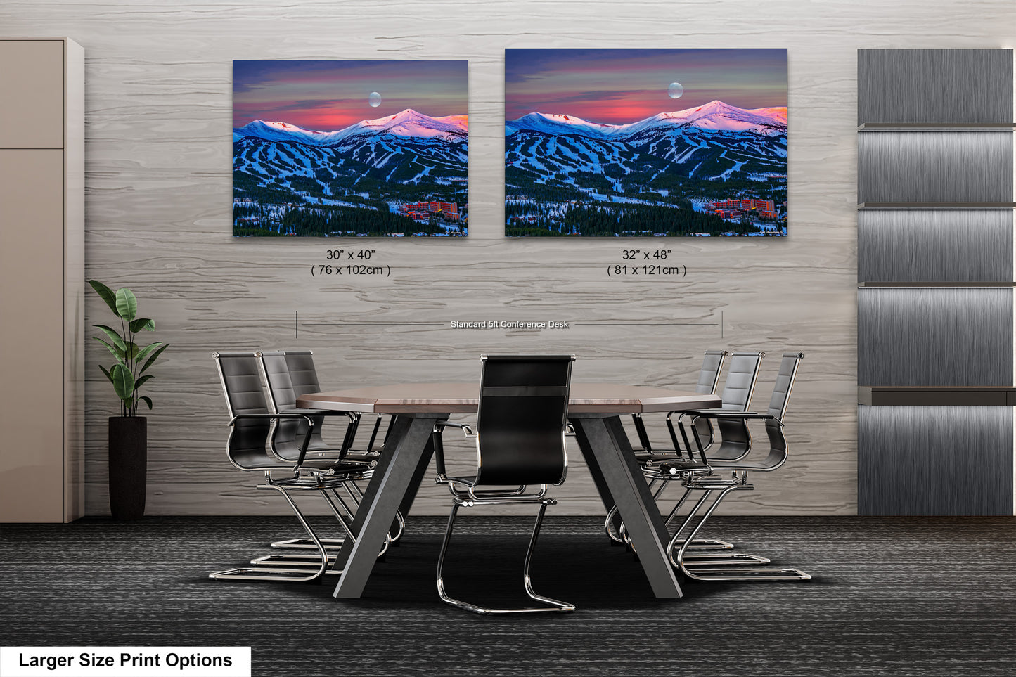 a dining room table with chairs and two pictures of mountains