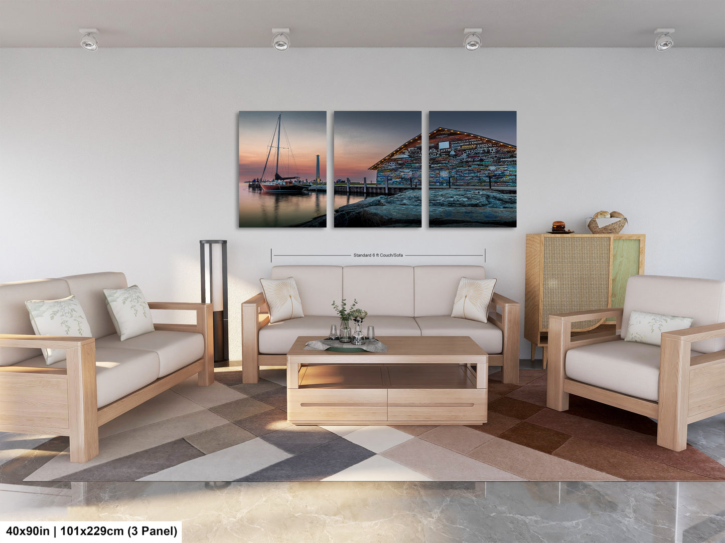 The image is a modern living room with a large wall art piece depicting a seascape with a boat and a dock. The room is furnished with a white sofa, a coffee table, and a potted plant. The overall design and decor create a stylish and contemporary atmosphere.