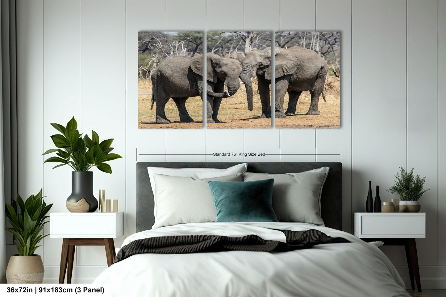a couple of elephants standing next to each other on a bed