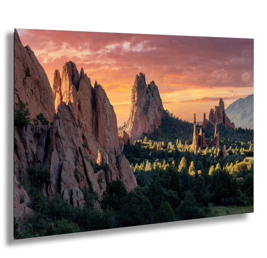 a scenic view of a mountain range with a sunset in the background