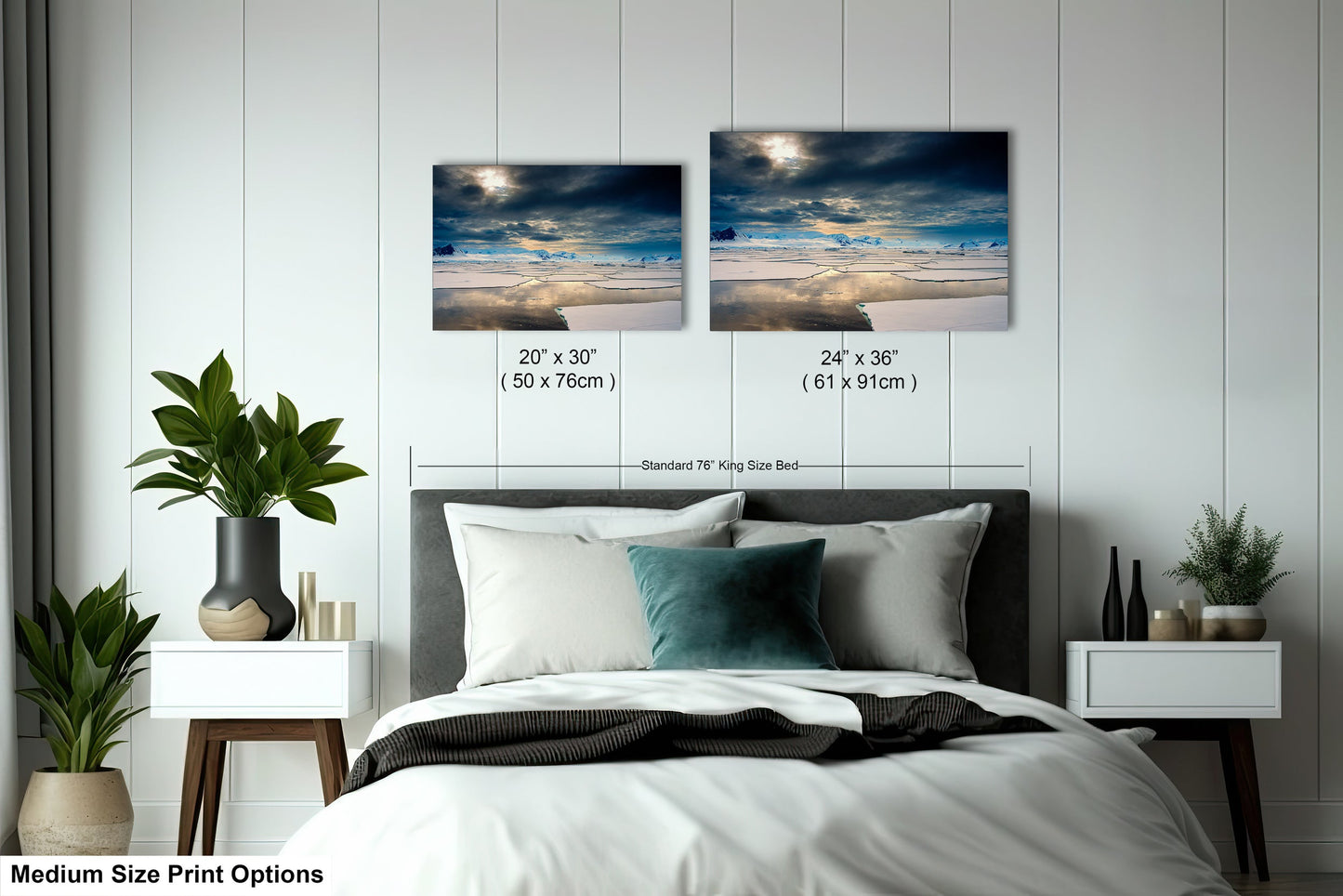 a bed with two pictures on the wall above it