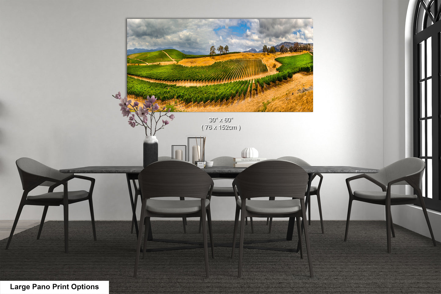 a dining room table with chairs and a painting on the wall