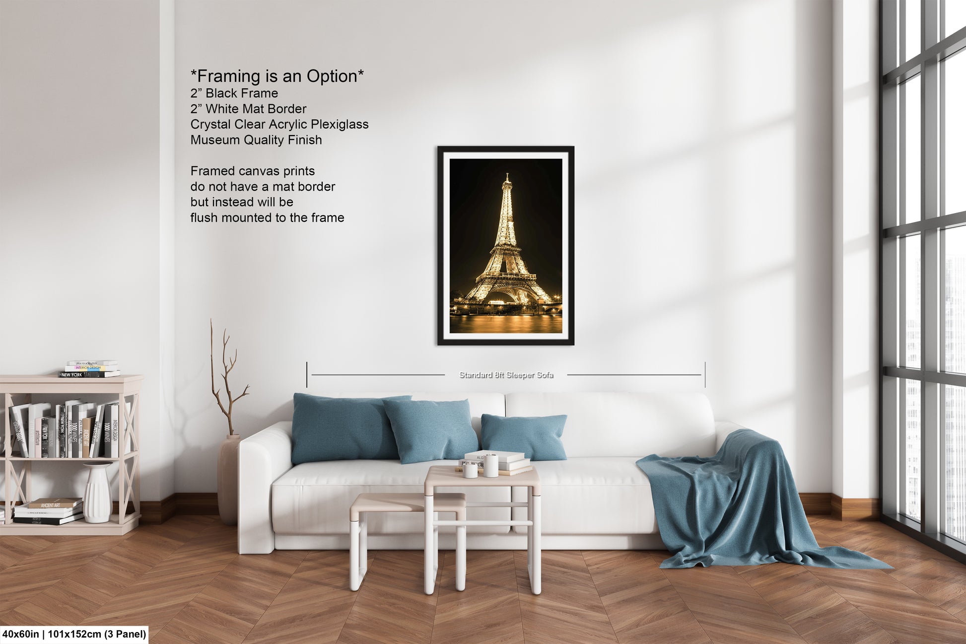 a living room with a white couch and a picture of the eiffel tower