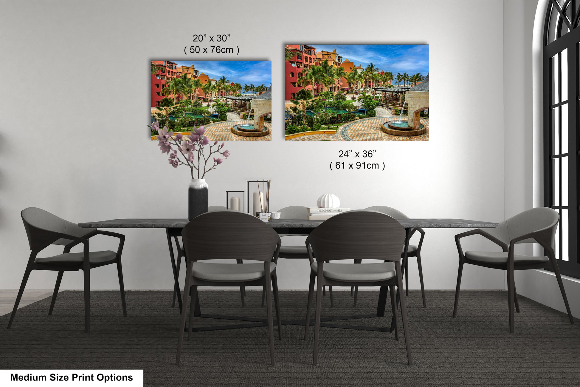 a dining table with four chairs and a vase of flowers