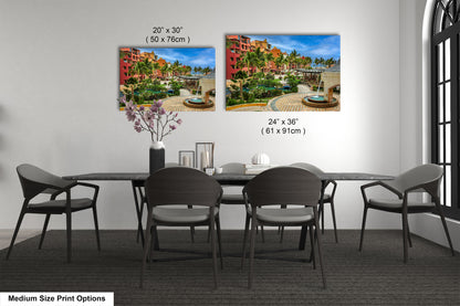 a dining table with four chairs and a vase of flowers