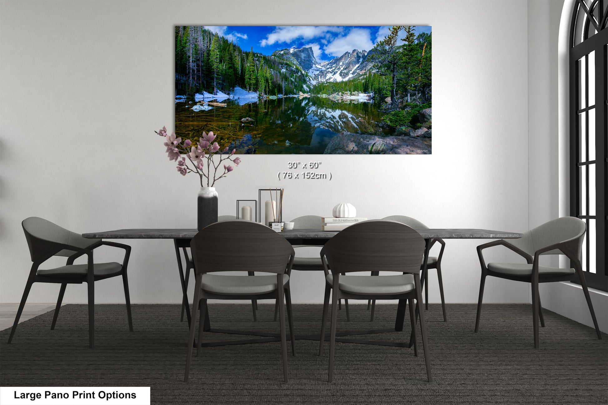 a dining room table with chairs and a painting on the wall