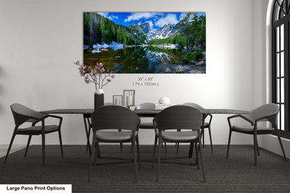 a dining room table with chairs and a painting on the wall