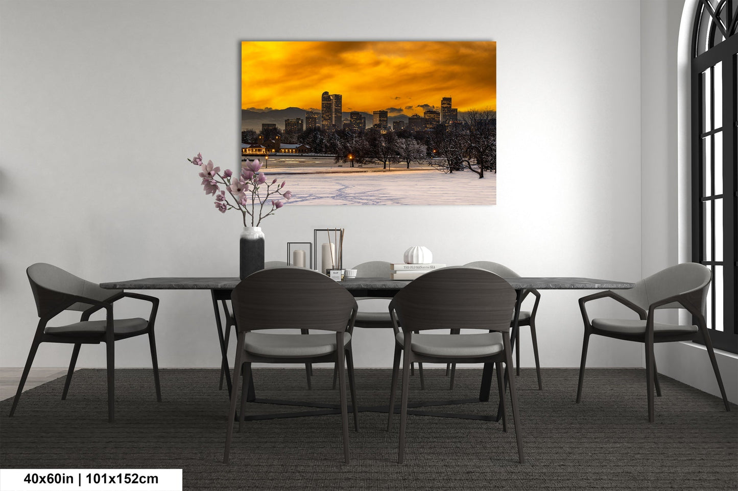 a dining room table with chairs and a painting on the wall