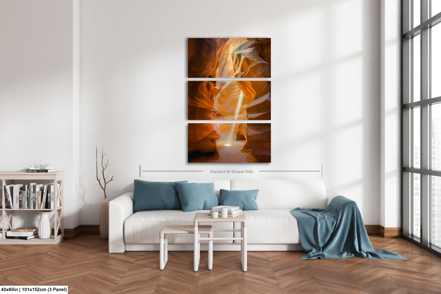 a living room with a white couch and a painting on the wall