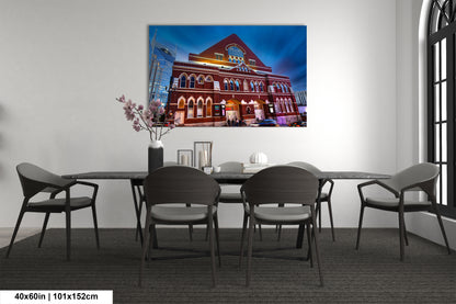 a room with a table and chairs and a painting on the wall