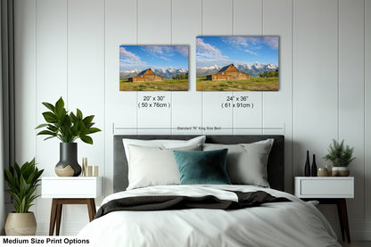 a bedroom with a bed and two pictures on the wall