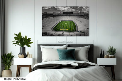 a bed in a room with a picture of a football stadium