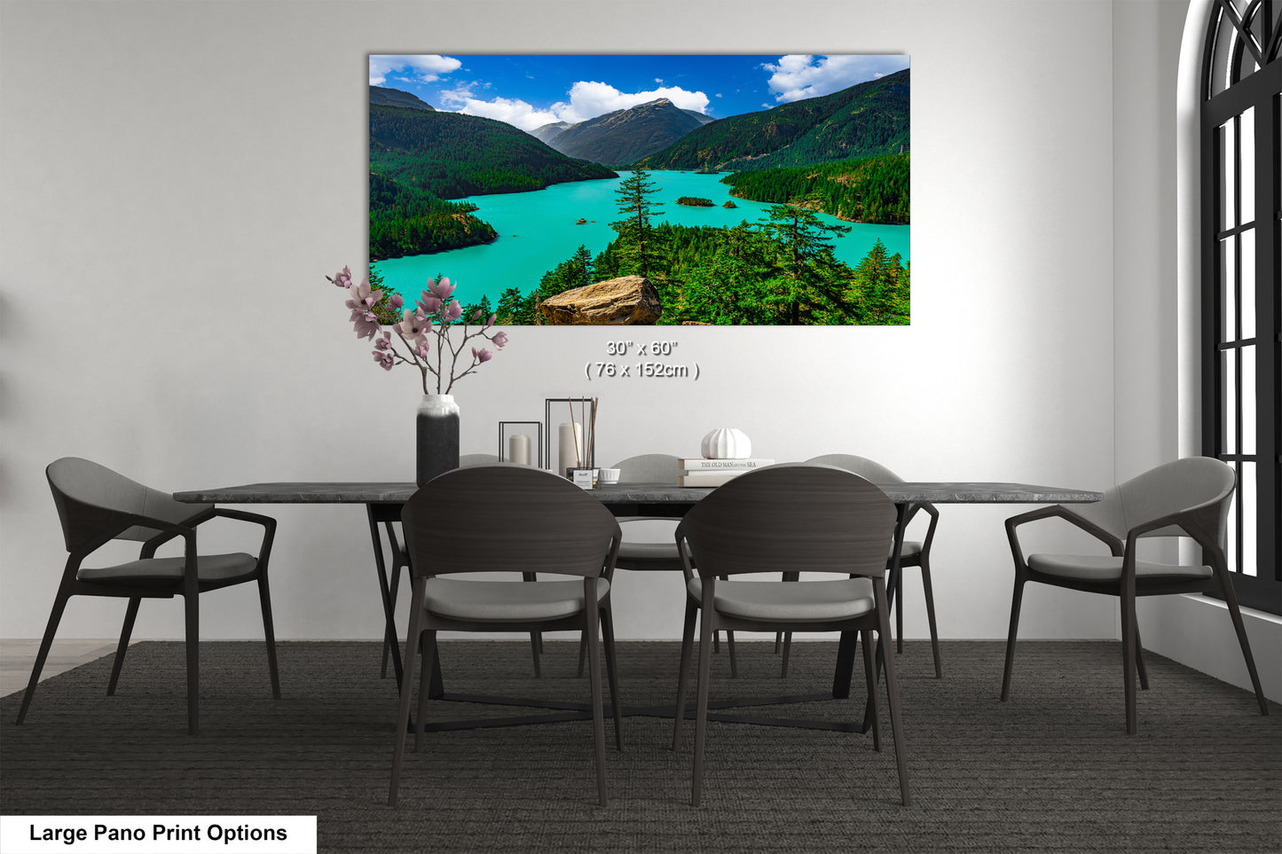 A large pano print depicting a scenic mountain landscape with a turquoise lake, surrounded by lush green forests.