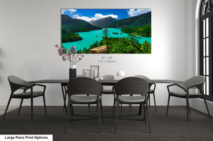 A large pano print depicting a scenic mountain landscape with a turquoise lake, surrounded by lush green forests.