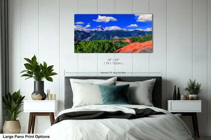 a bedroom with a large bed and a mountain view