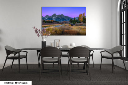 a dining room table with chairs and a painting on the wall