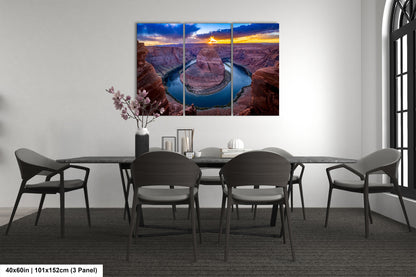 a dining room table with chairs and a painting on the wall