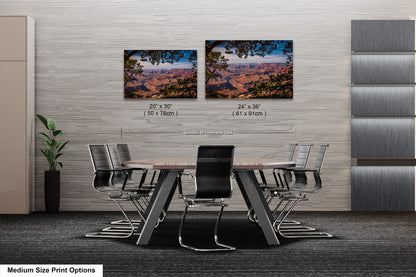 a dining room table with four chairs and a picture of the grand canyon