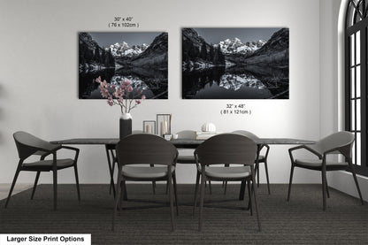 a black and white photo of a dining room table