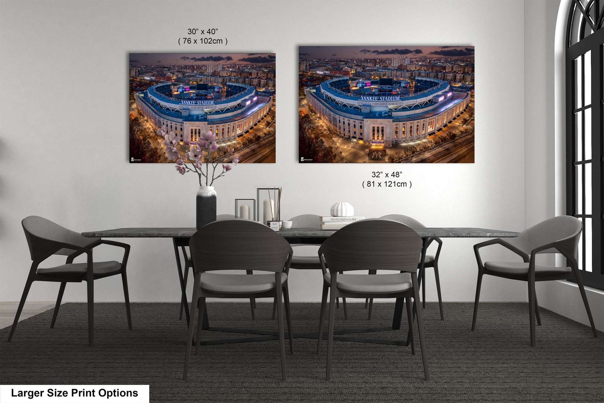 a dining room table with four chairs and two pictures of a stadium