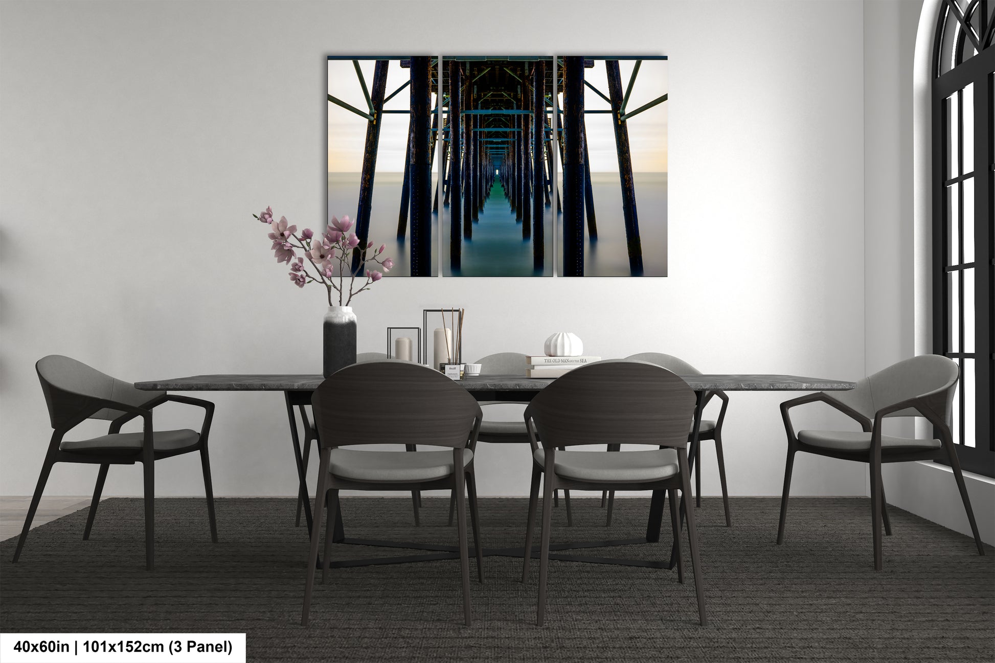 a room with a table and chairs and a painting on the wall