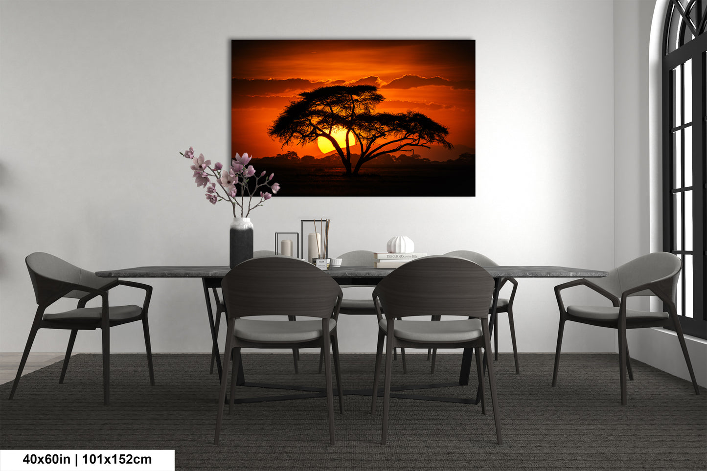 a dining room table with chairs and a painting on the wall