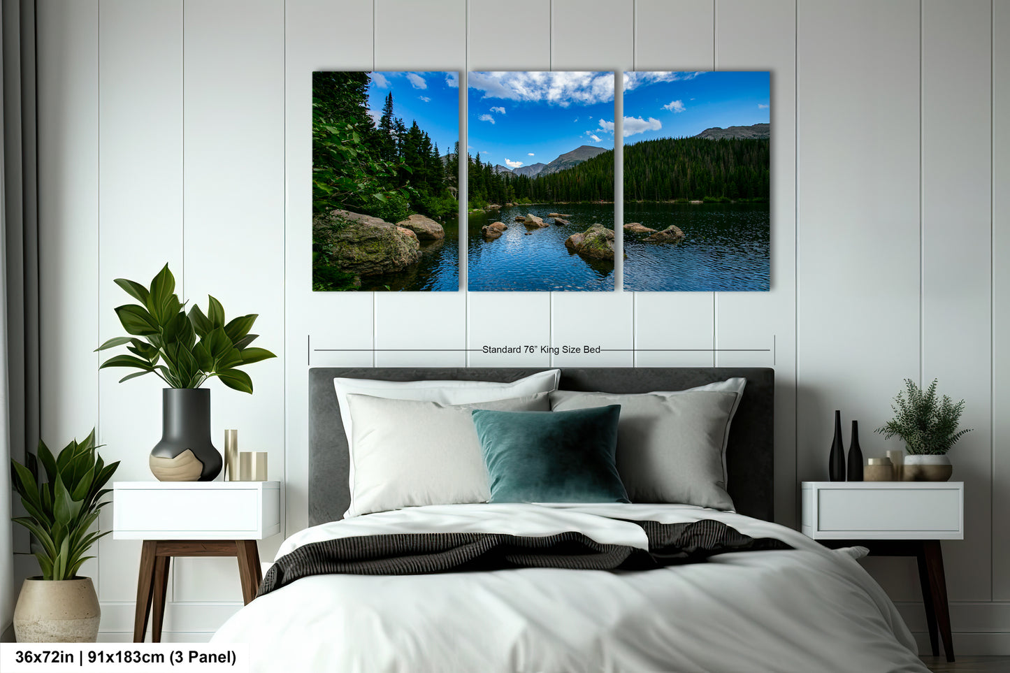 A bedroom with a large, three-panel landscape painting hanging on the wall above the bed. The painting depicts a serene lake surrounded by trees and mountains, creating a peaceful and natural atmosphere.