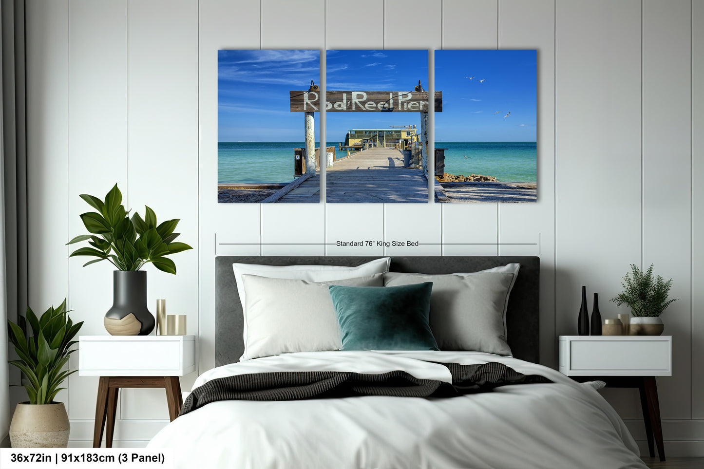 a bed room with a neatly made bed and two paintings on the wall
