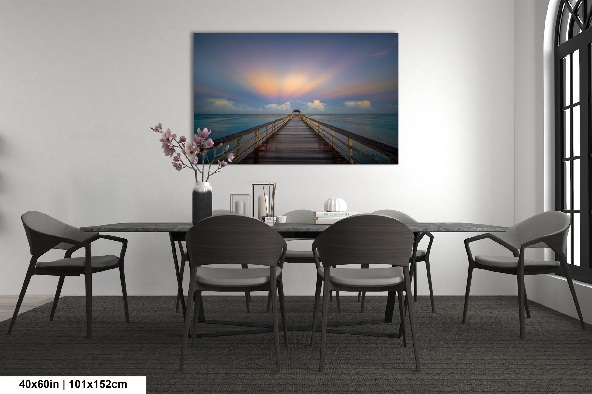 a dining room table with chairs and a painting on the wall
