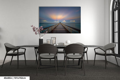a dining room table with chairs and a painting on the wall