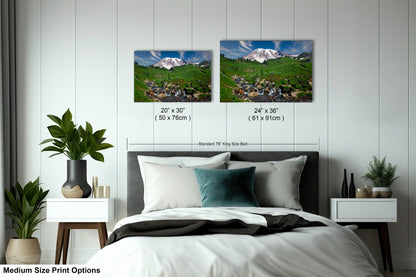 a bedroom with a bed and two pictures on the wall